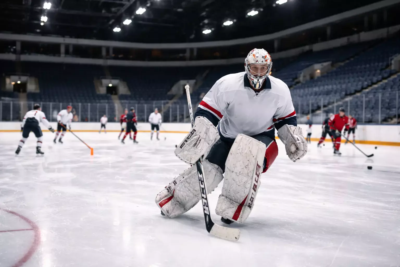 Hockey team morning practice with goaltender on ice